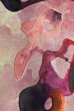 Abstract artwork featuring a textured cream-colored form on the left, blending into a backdrop of muted purple and pink hues. Swirling shapes of deep red, purple, and black intertwine and overlap in the foreground, creating a dynamic and flowing composition with various textured and smooth areas.