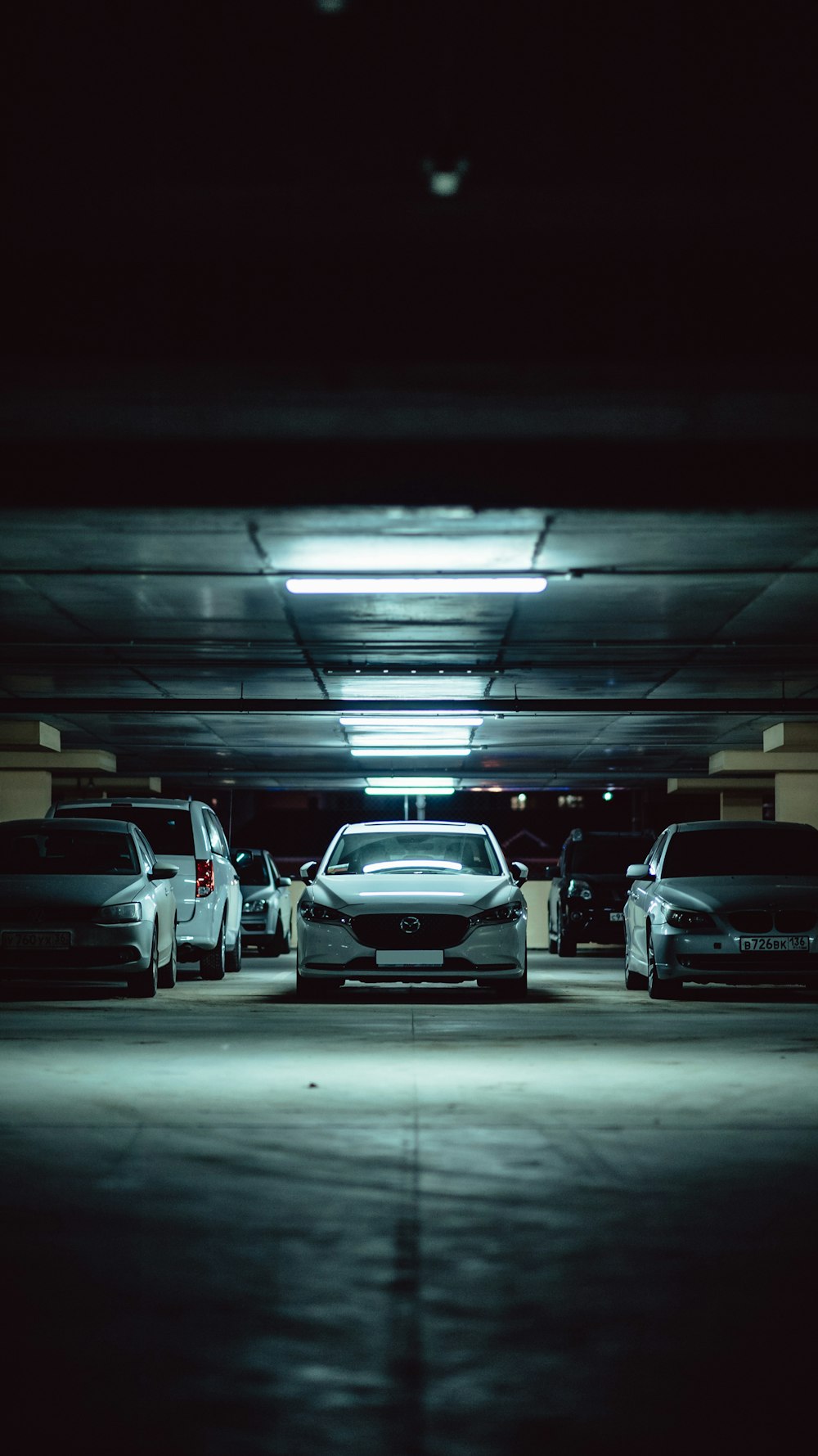 a group of cars parked in a parking garage