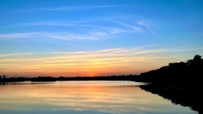 A serene sunset over a calm lake symbolizing peaceful transformation and new beginnings.