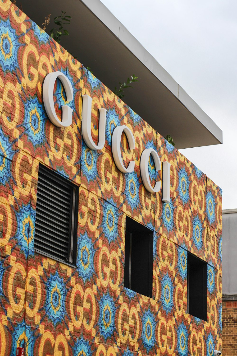 a colorful building with a sign that says guco on it
