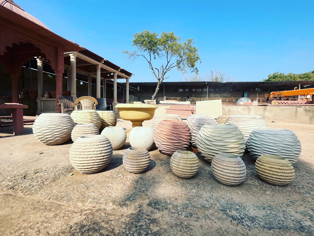 a bunch of vases that are sitting on the ground