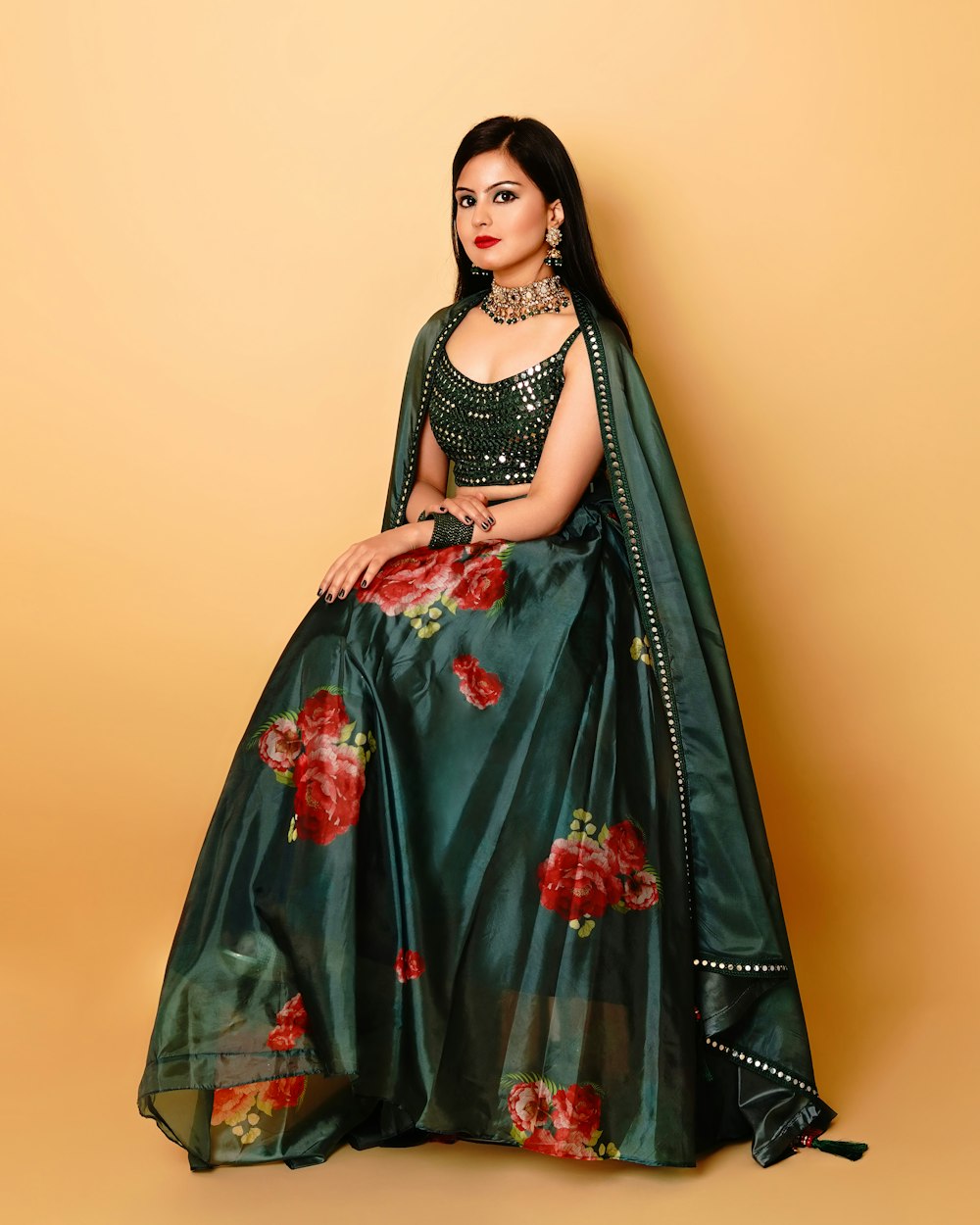 a woman in a green and red lehenga