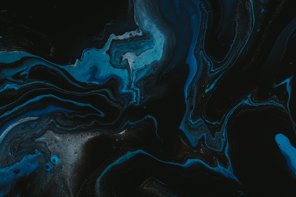 a black and blue abstract painting with a black background