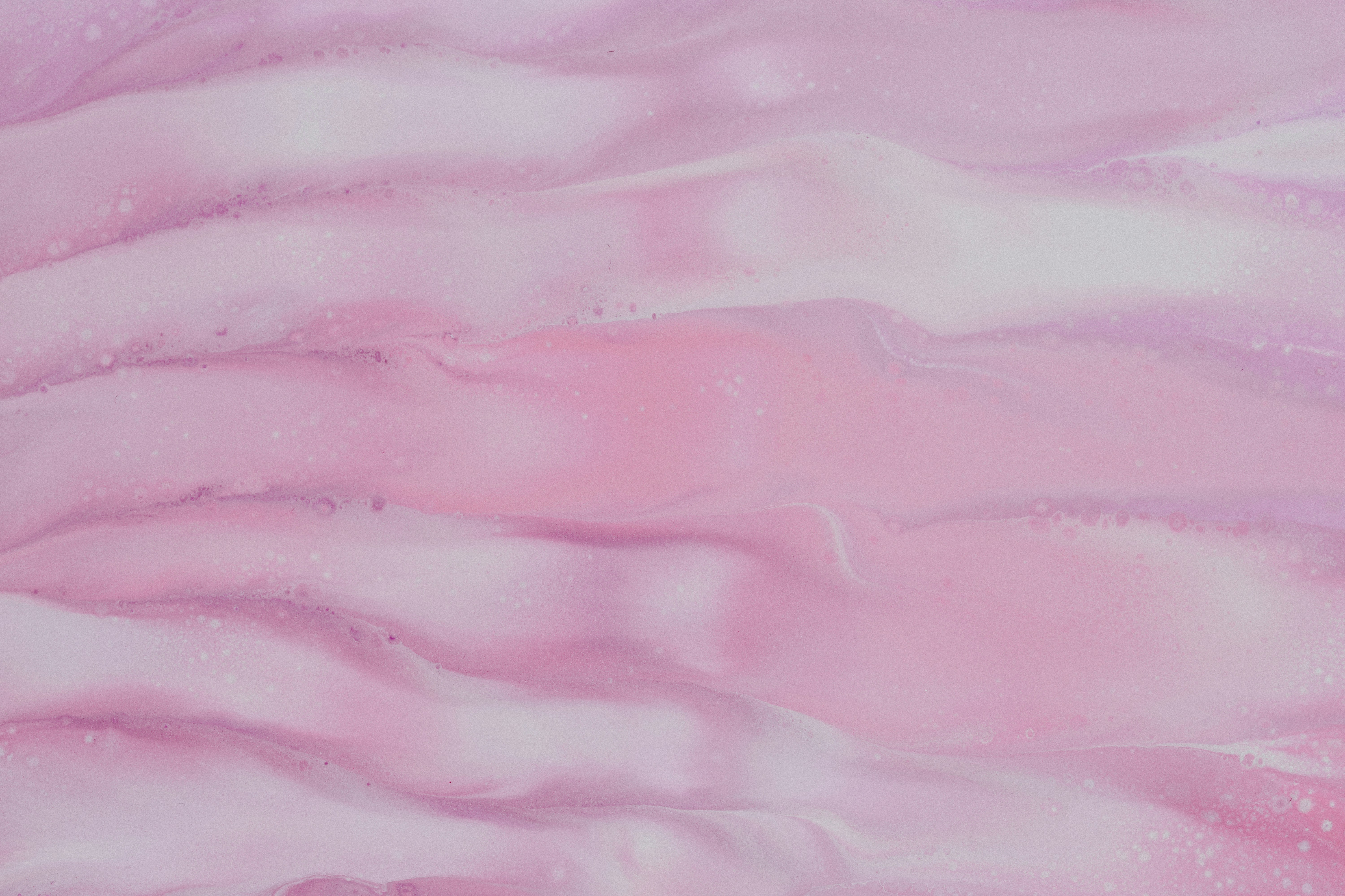 a close up of a pink and white background, 