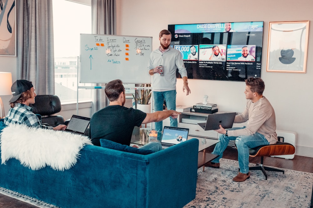 a group of people sitting around a living room