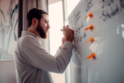 A focused entrepreneur reviewing notes and planning next steps in a bright office.