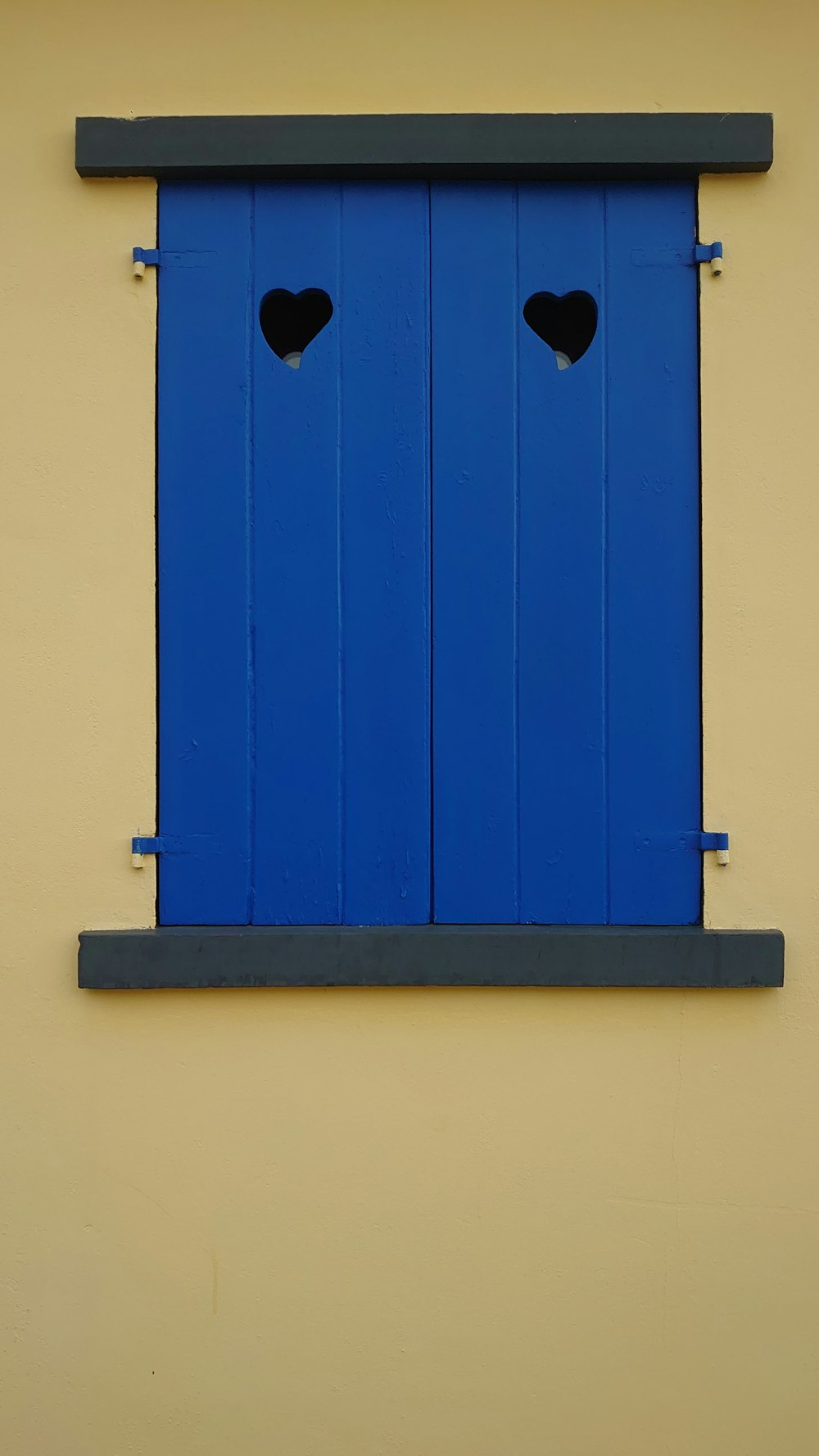 a blue window with two hearts cut out of it