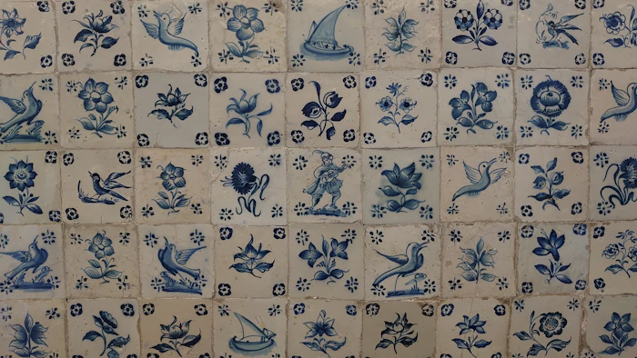 A blue and white tiled wall with flowers and birds
