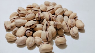 a pile of nuts on a white surface