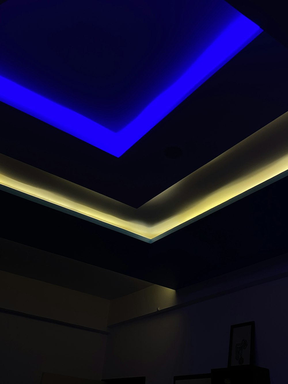 a room with a blue ceiling and a black wall