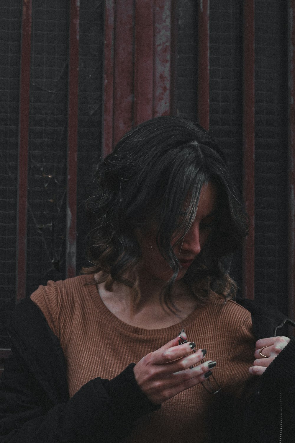 a woman holding a cigarette in her hands