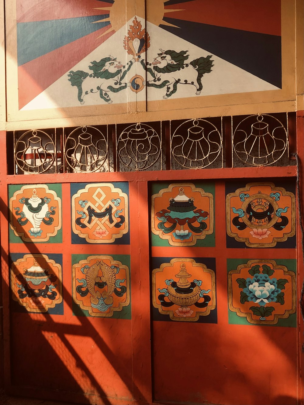 a wooden door with decorative designs painted on it