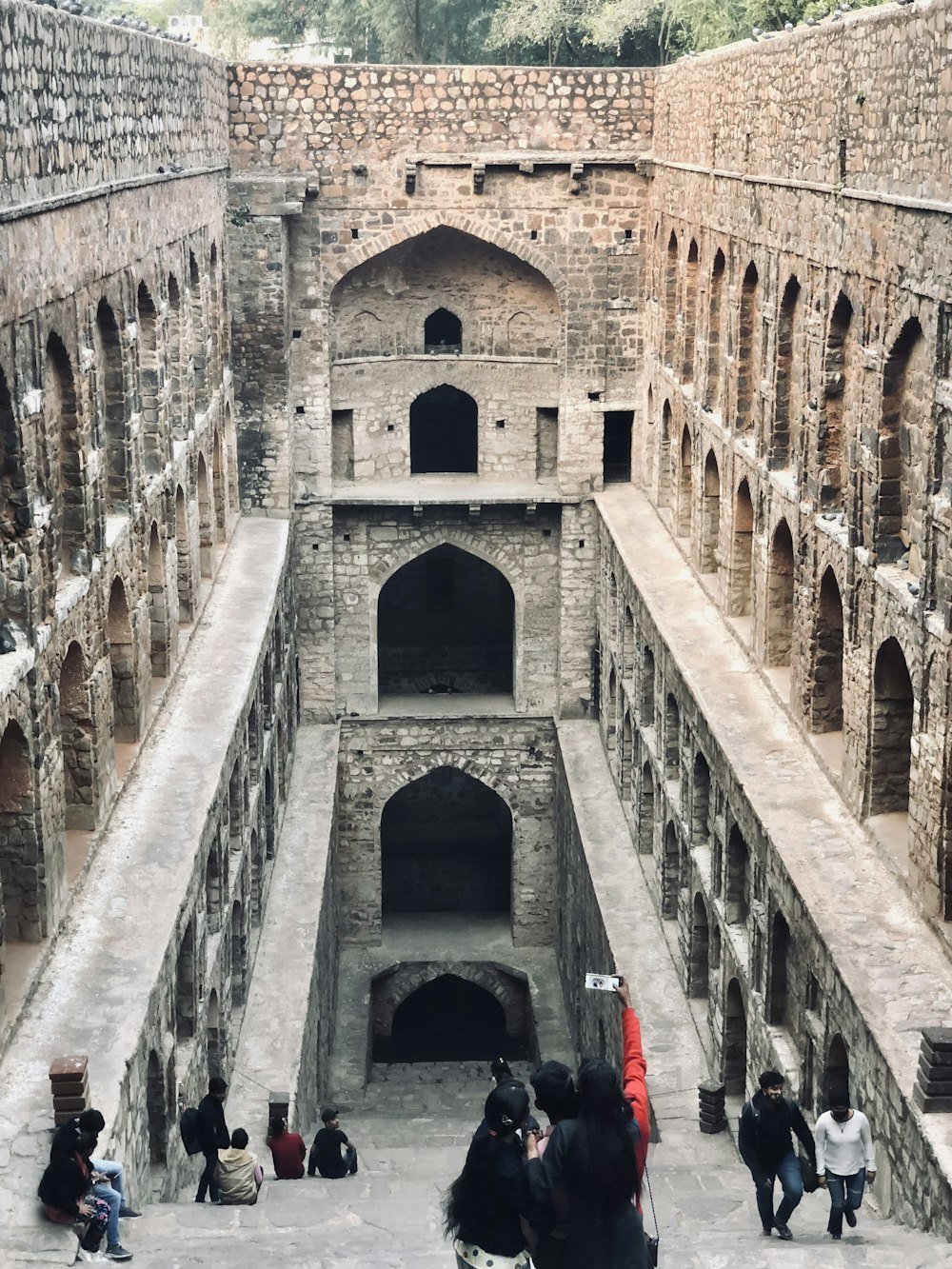 a group of people standing inside of a stone building