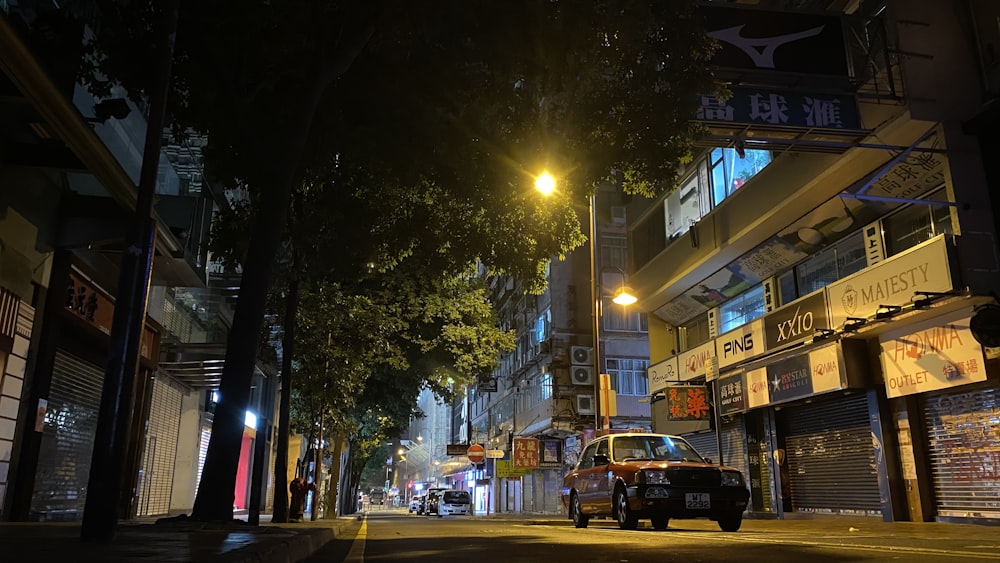 a car parked on the side of a street at night