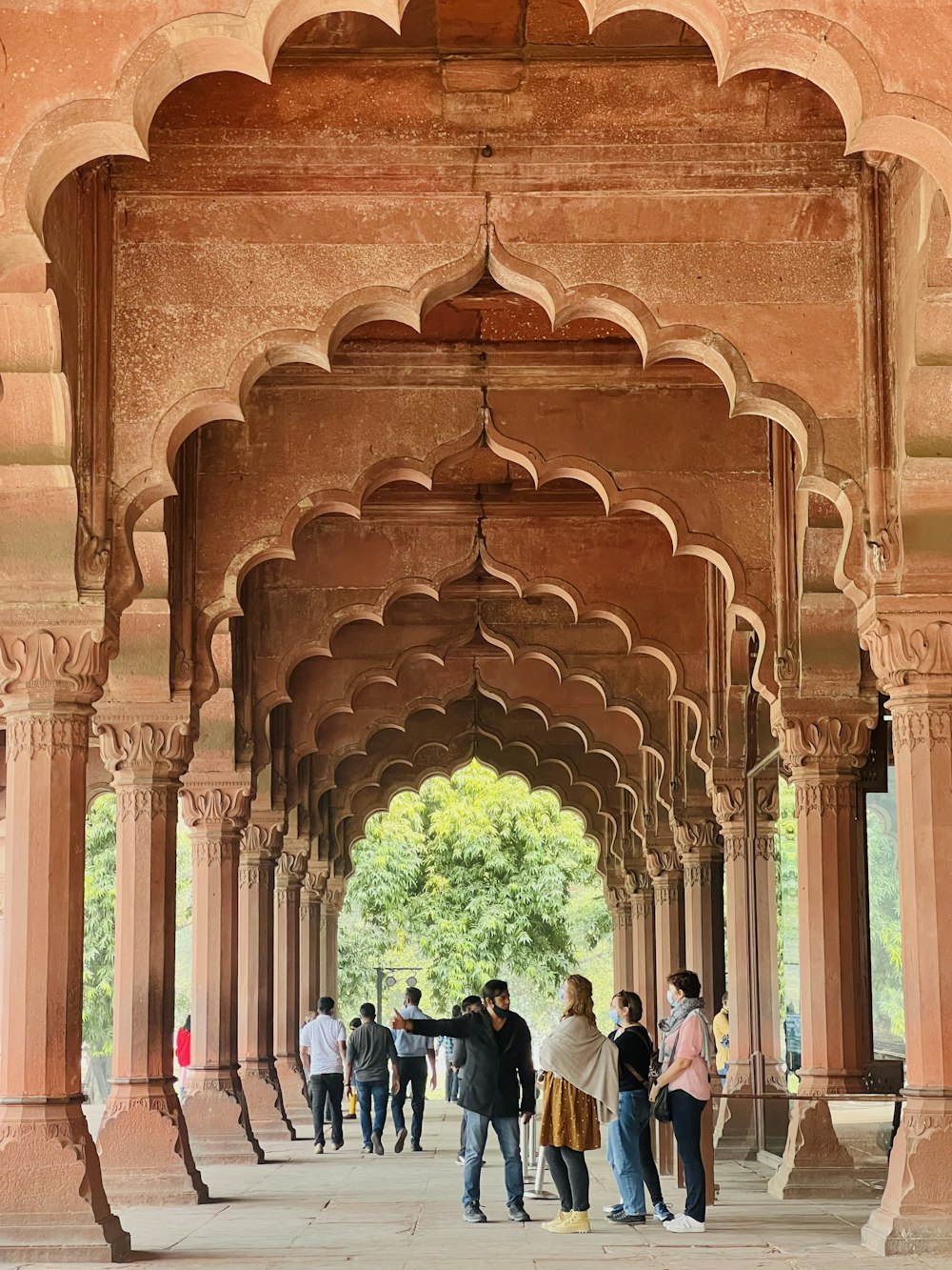 a group of people standing under an archway