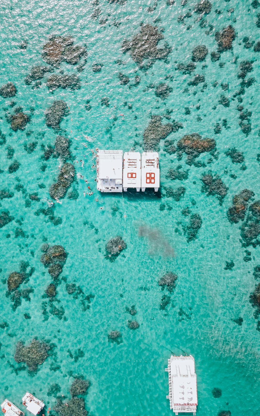 a couple of boats floating on top of a body of water