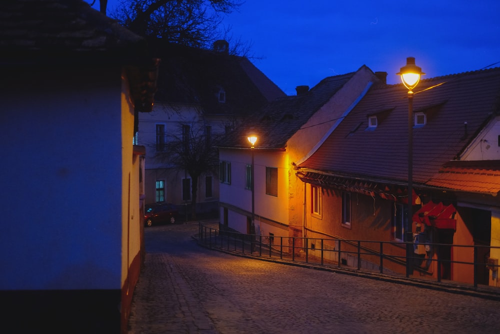 a couple of people standing outside of a building at night