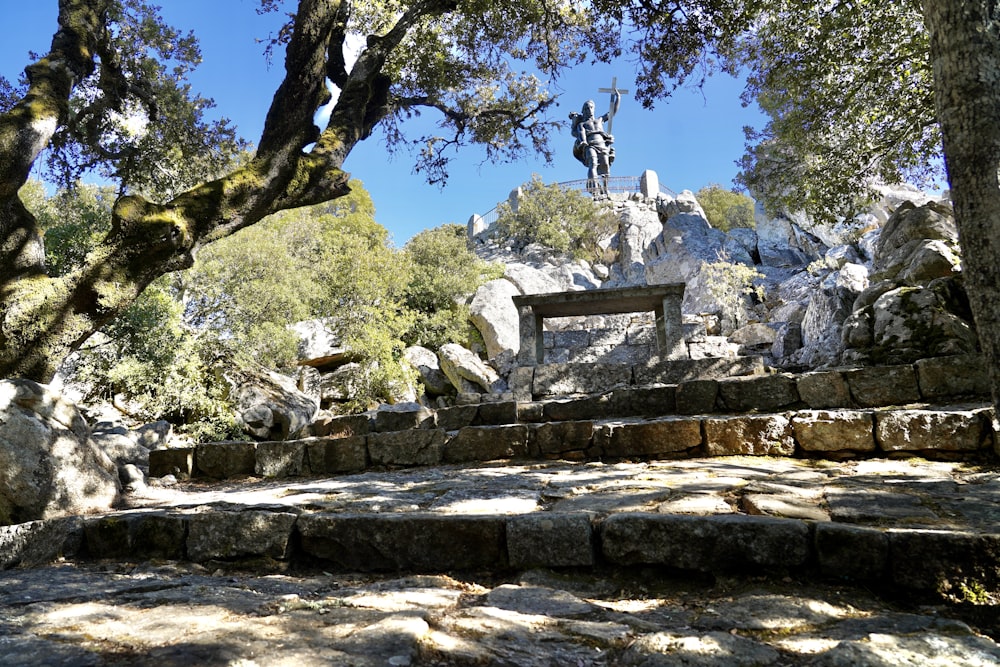 a stone structure with a statue on top of it