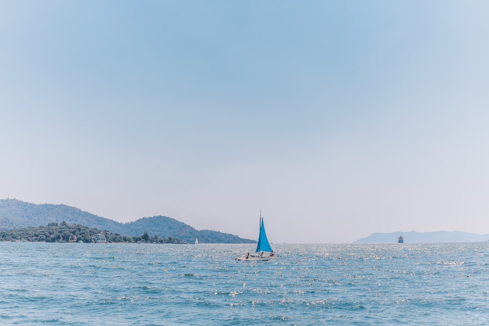 a sailboat in the middle of a body of water