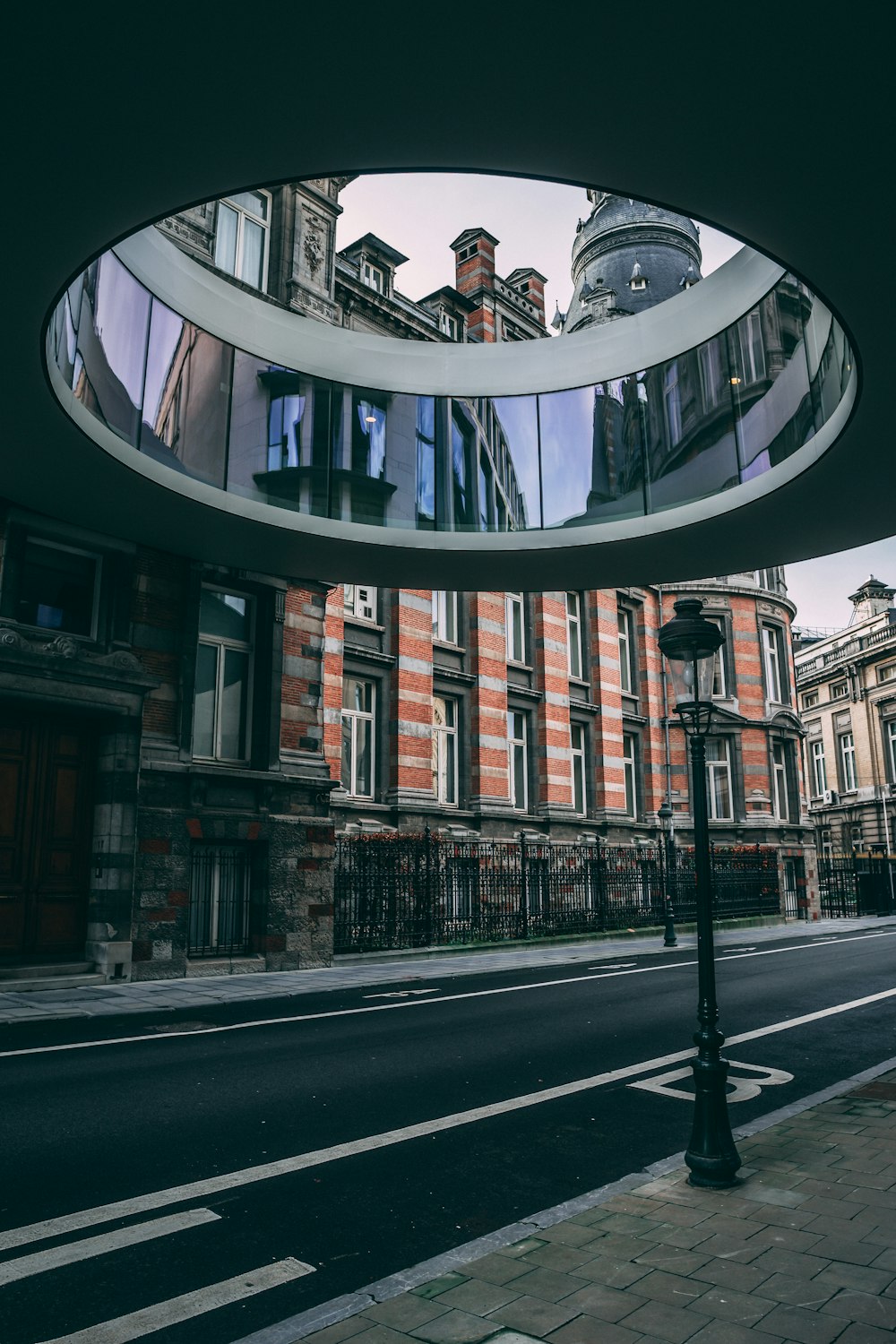 a building with a circular mirror on the side of it