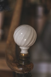 A close-up of sleek cabinet handles and knobs arranged on a wooden surface.