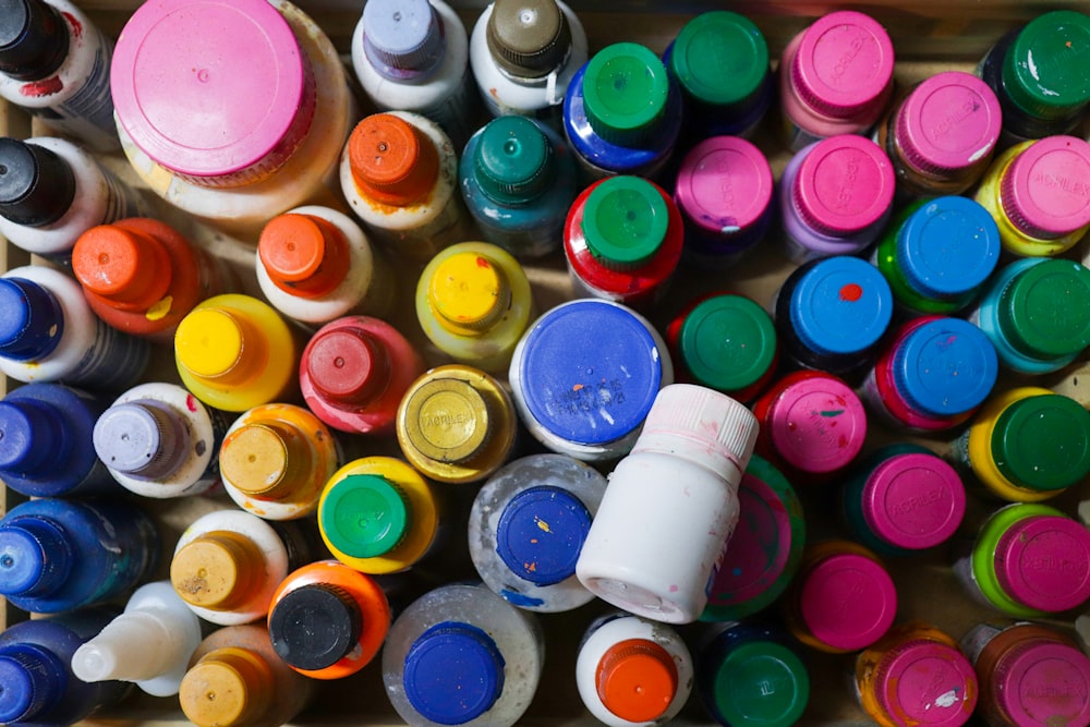 a bunch of different colored paint in a box
