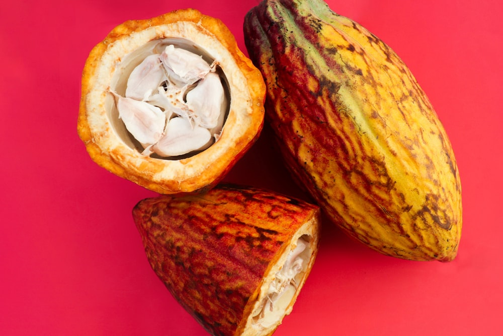 a close up of a fruit on a pink background