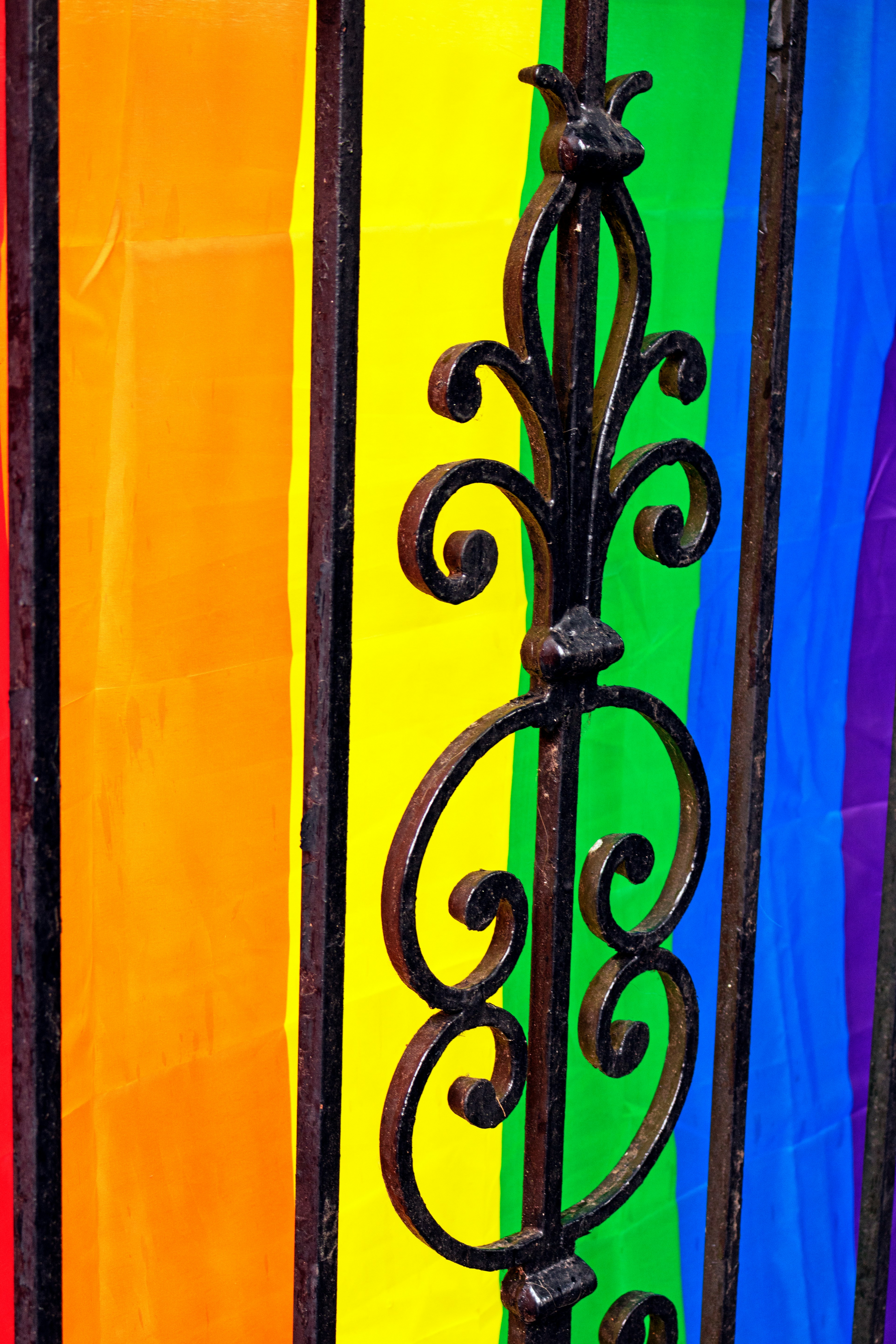 Rainbow Pride flag behind wrought-iron fence in Atlanta