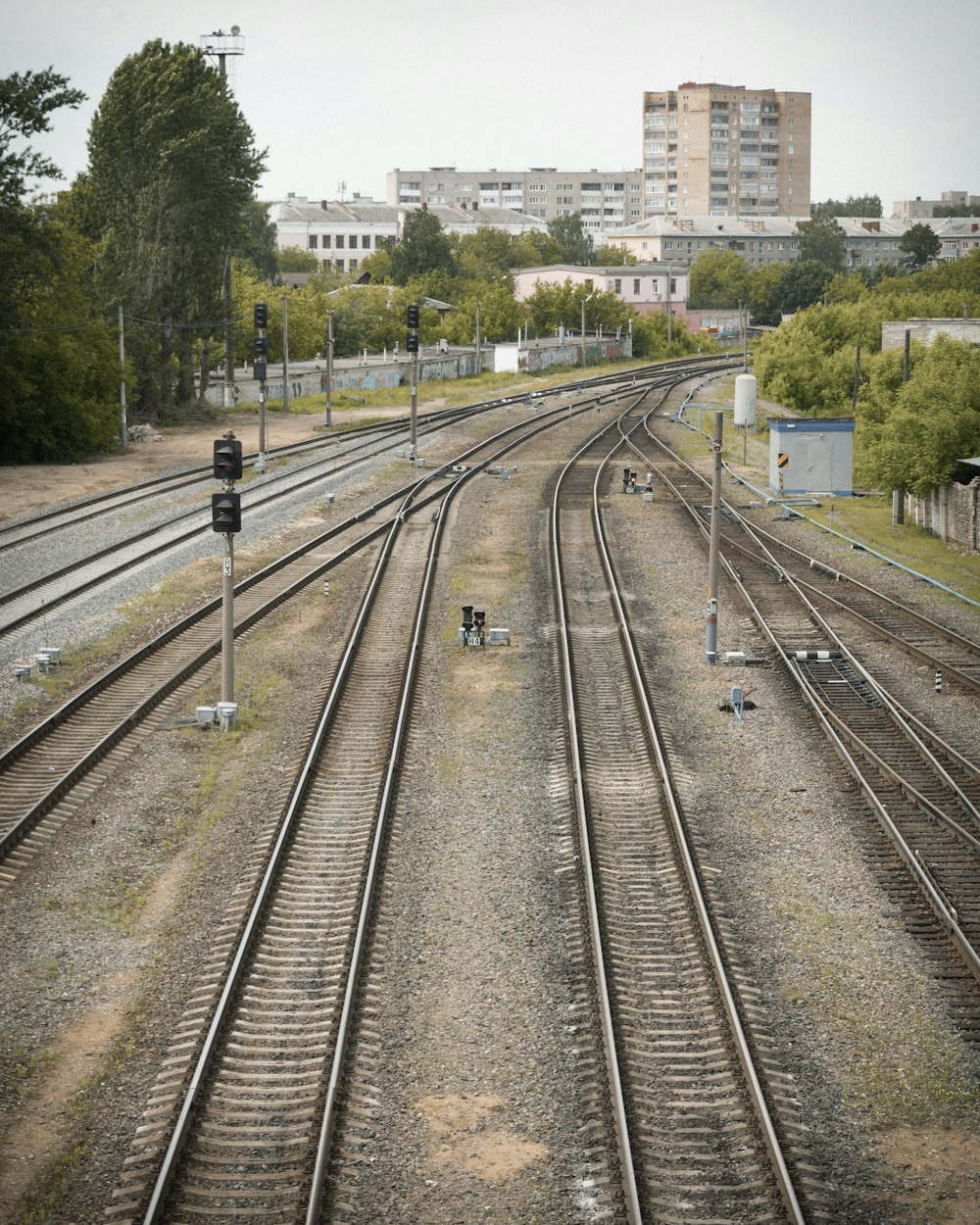 a view of a train track with buildings in the background
