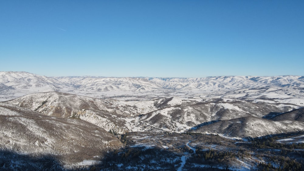 a view of a snowy mountain range from a ski lift