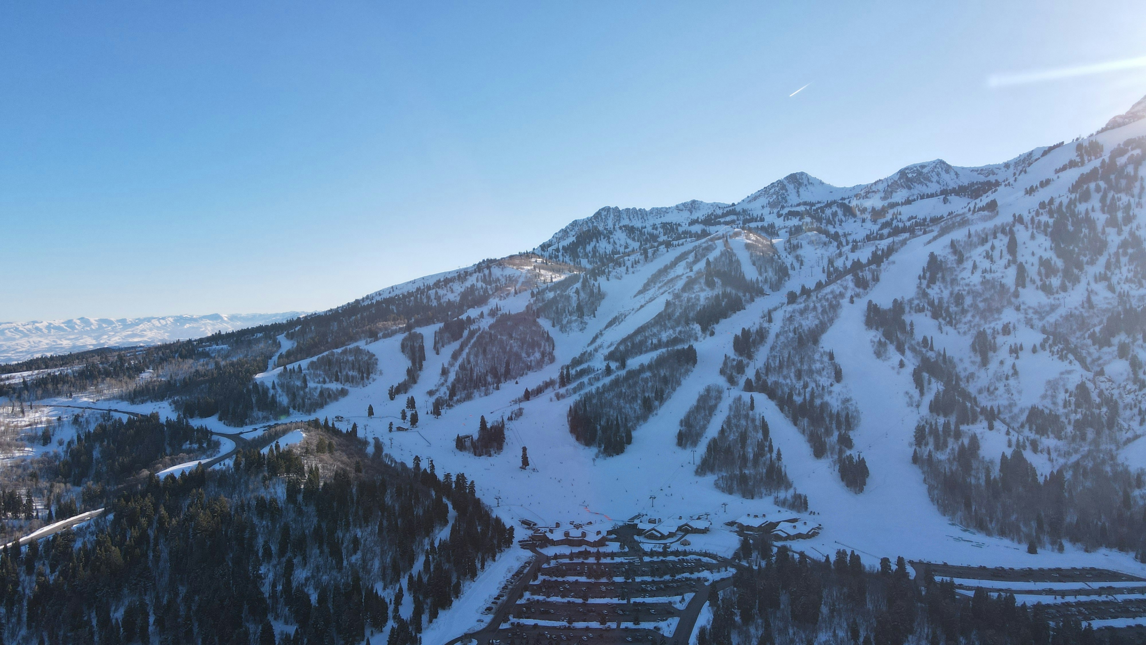a snow covered mountain with a ski lodge in the foreground