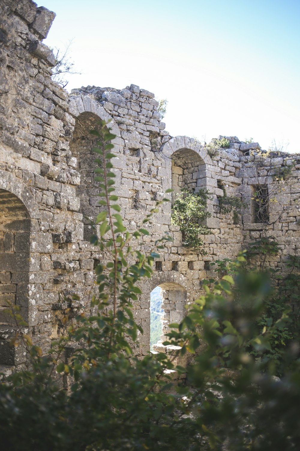 a view of a stone building through the trees