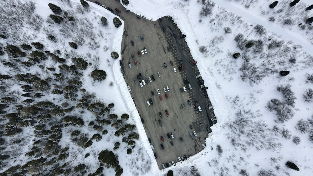 an aerial view of a parking lot covered in snow