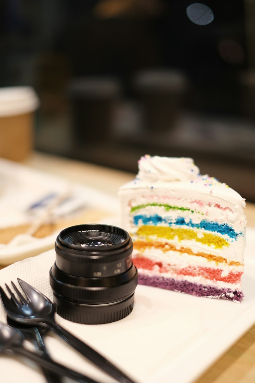 a piece of cake and a camera on a table