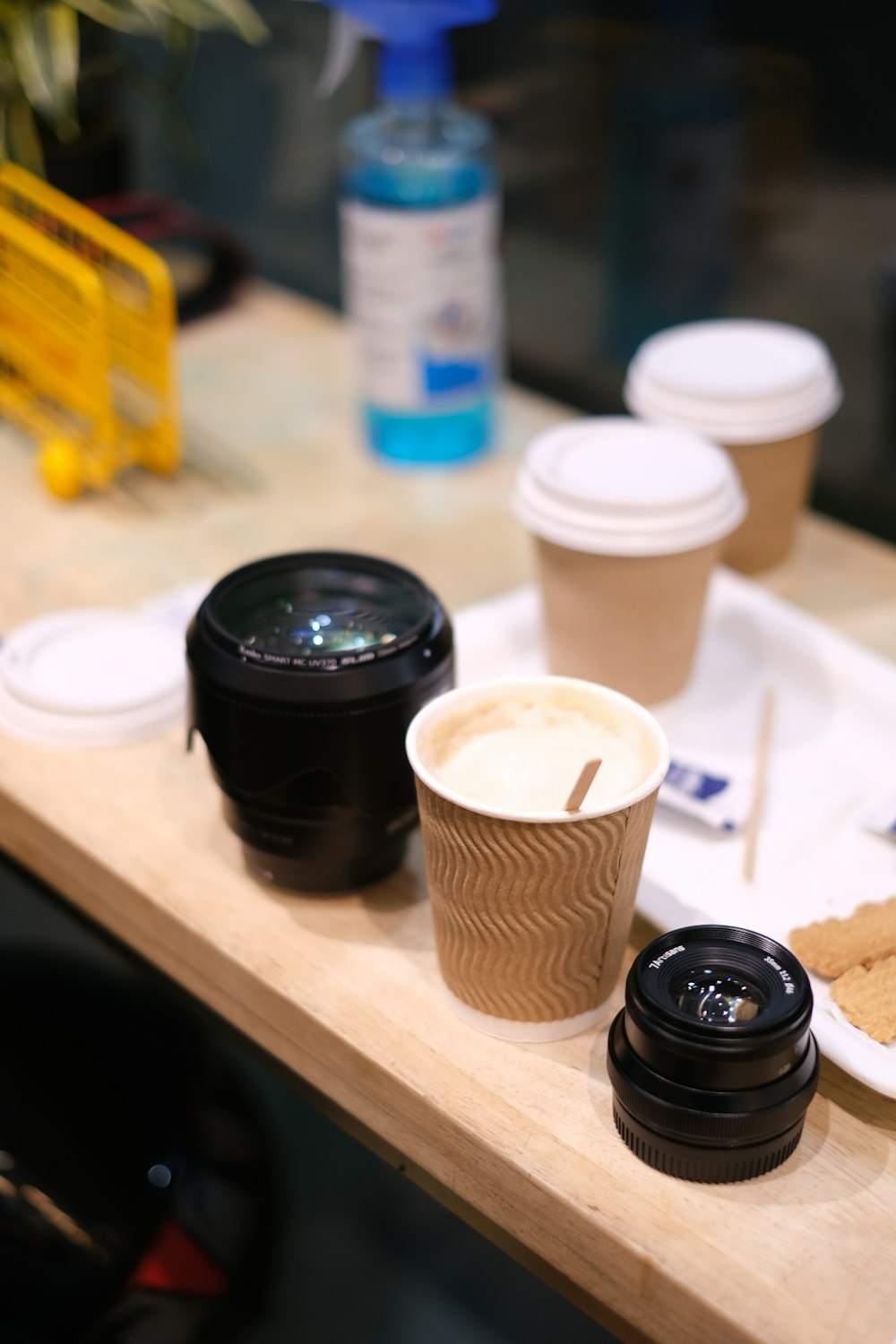 a table topped with cups and plates of food