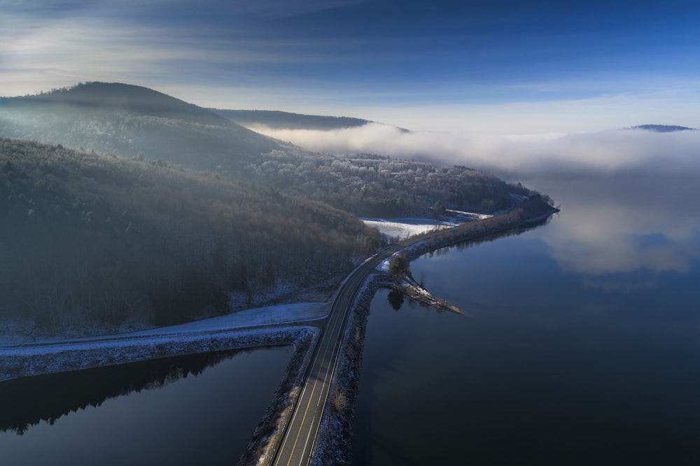 an aerial view of a road near a body of water