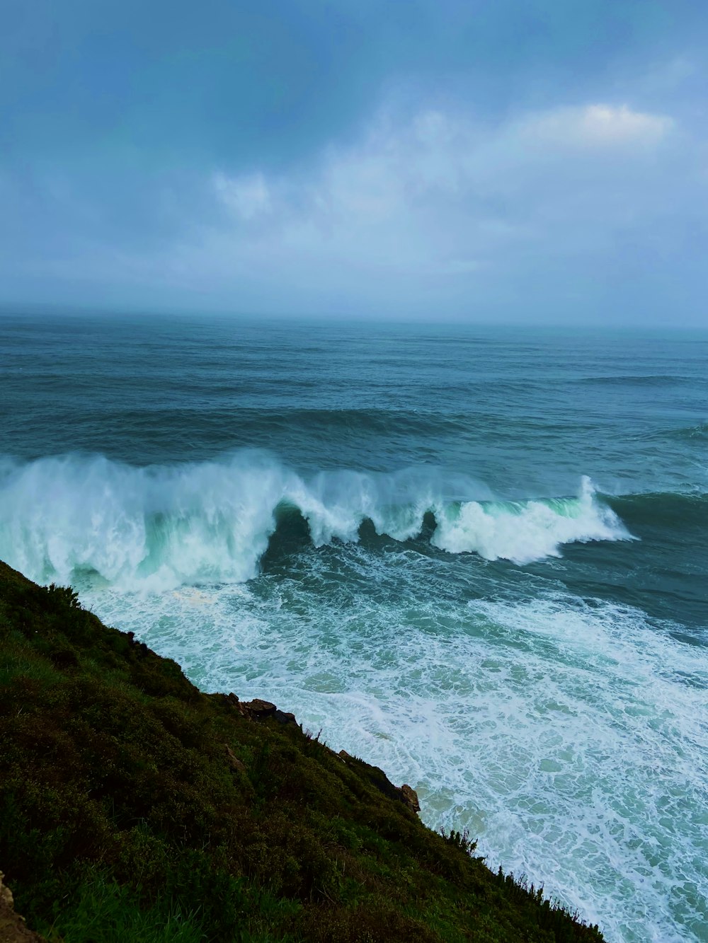 a large body of water near a cliff