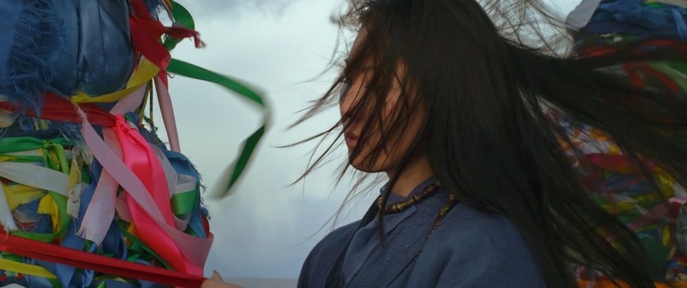 a woman holding a bunch of colorful streamers