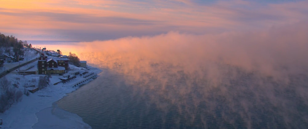 an aerial view of a snow covered lake