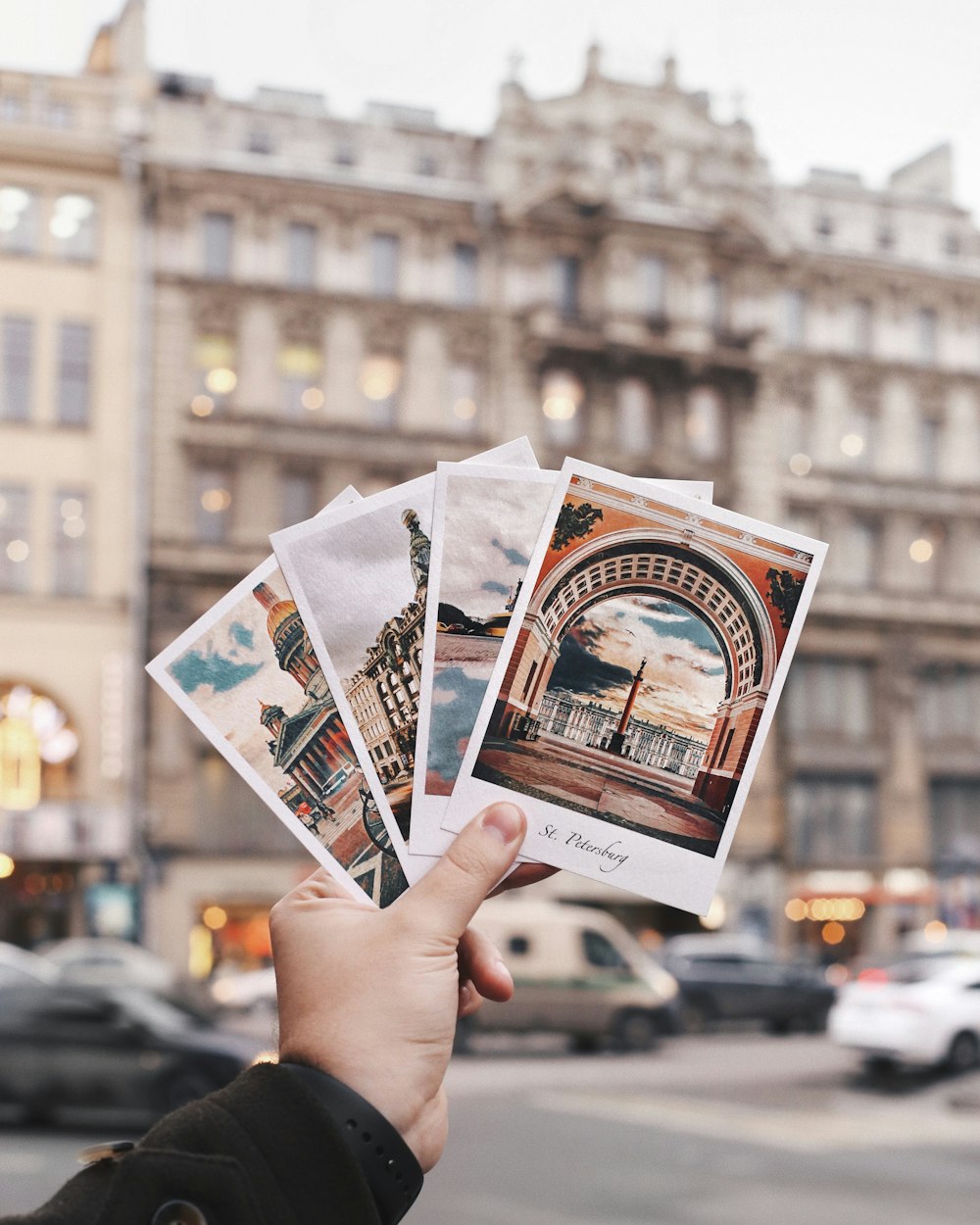 a person holding up four photos of a building