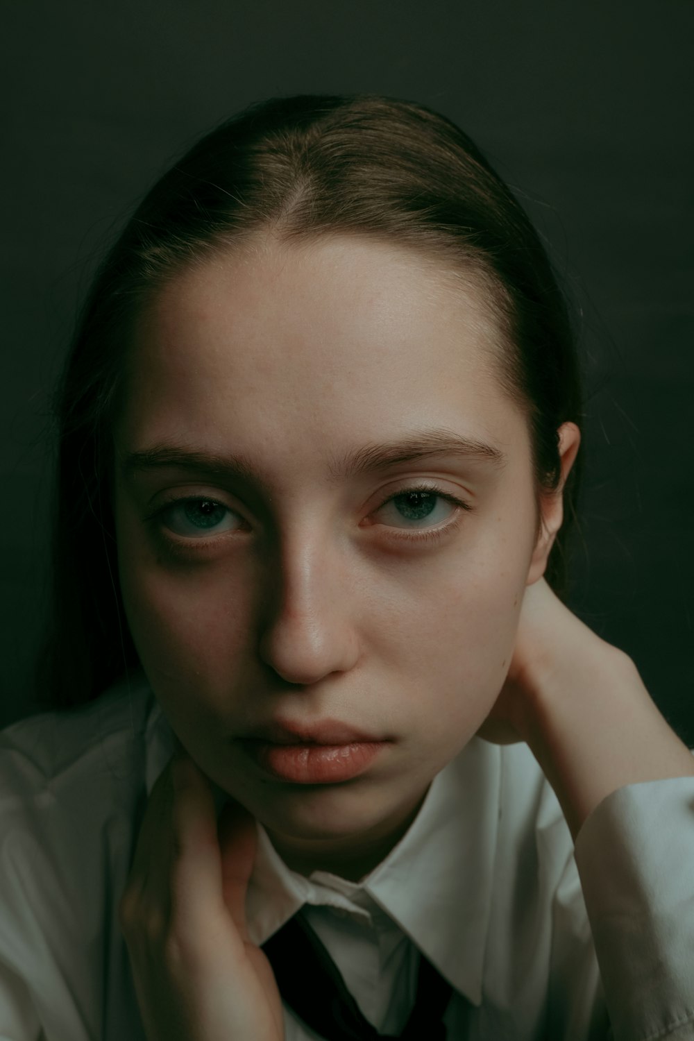 a woman in a white shirt and black tie