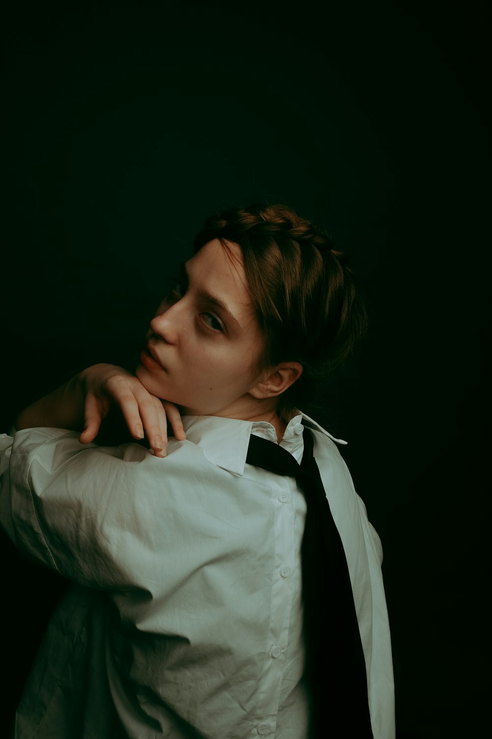 a woman in a white shirt and black tie