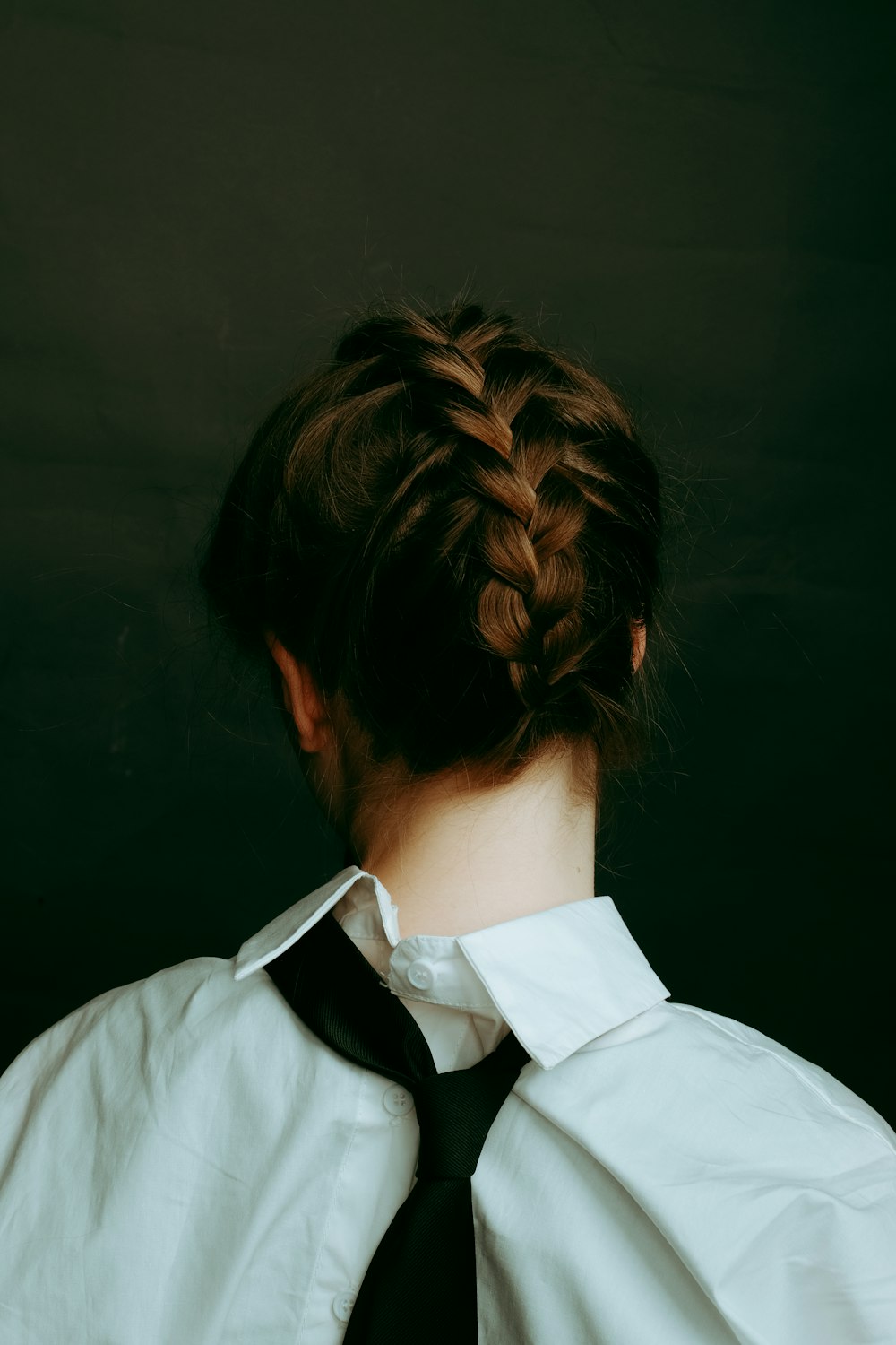 a woman with a black tie and a white shirt