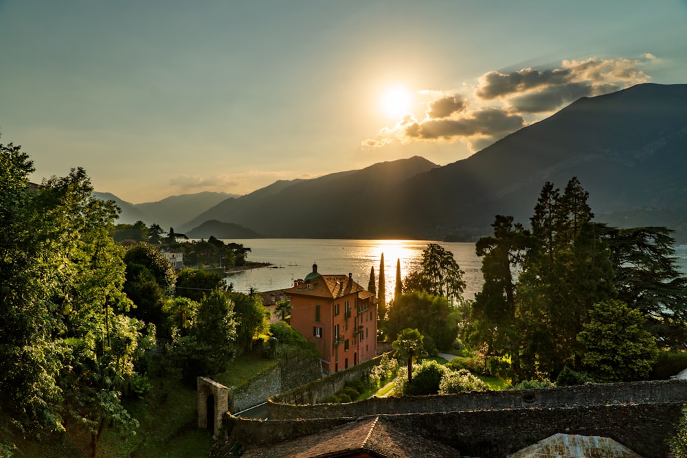 the sun is setting over a small village