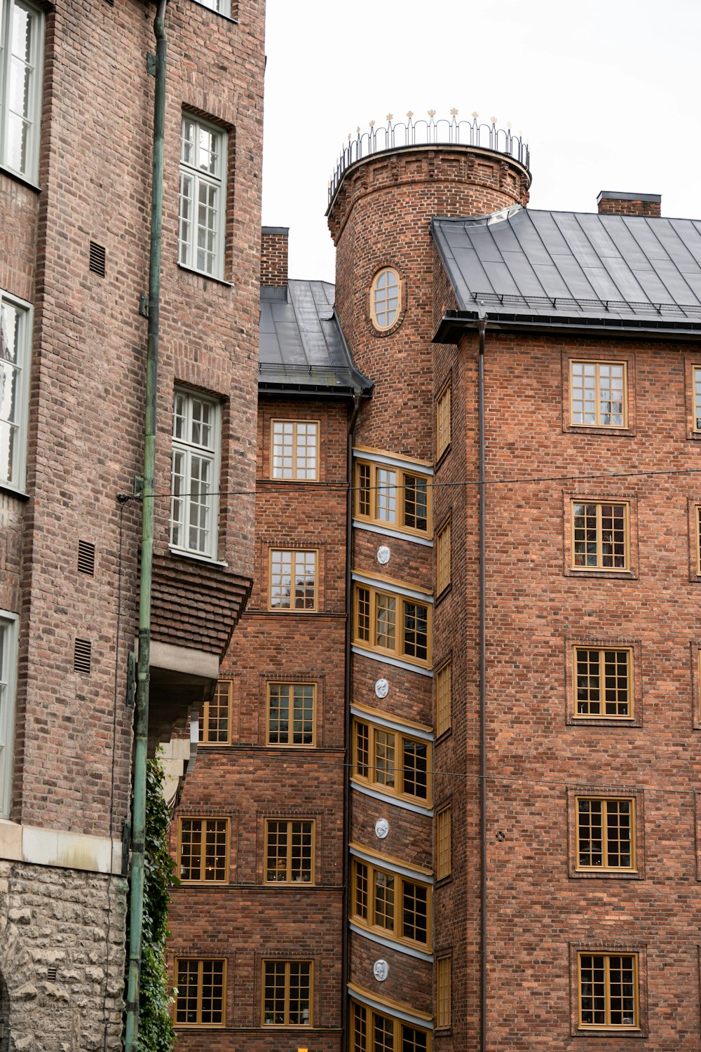 a tall brick building with a clock on the side of it