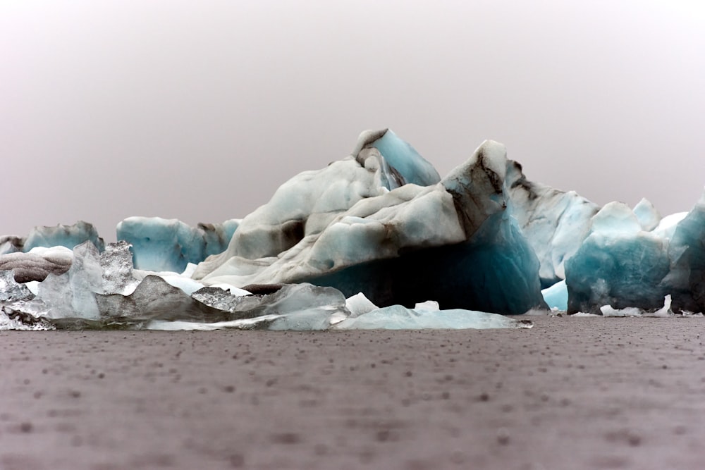a group of icebergs floating on top of a body of water