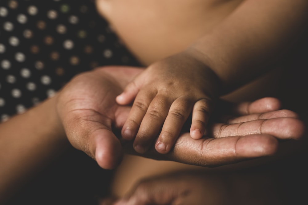 a close up of a person holding their hands together