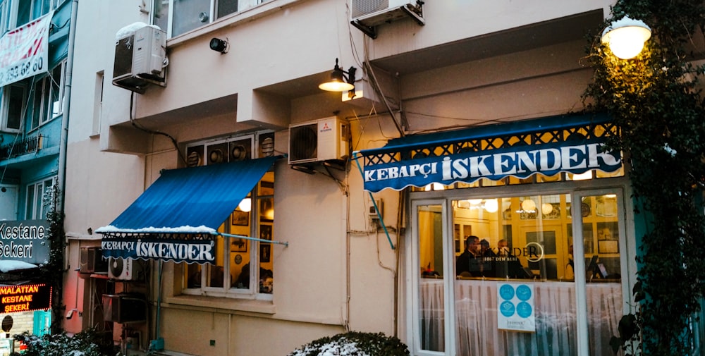 a store front with a blue awning and a blue awning