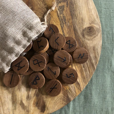 A handcrafted wooden DM screen etched with dark fantasy motifs and arcane symbols.