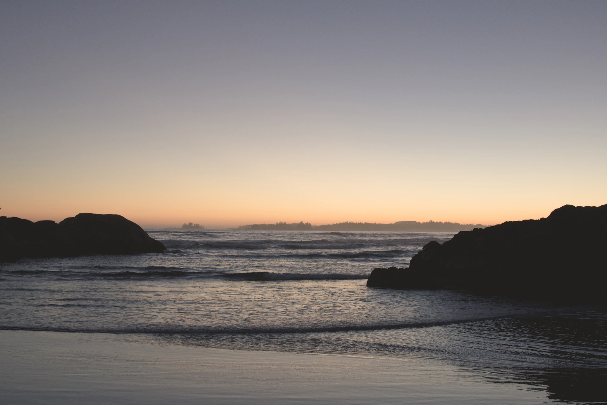 Rocky coastline with ocean and forest at Tofino, Vancouver Island